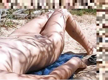 Beautiful Girl Relaxing Under The Sun On The Nudist Beach