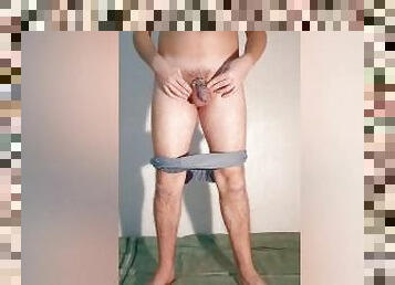 A guy shows what a chastity belt looks like in his underpants - a chastity cage in a boxers