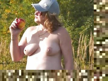 Nudist beach. Random guy watches naked MILF sunbathe no panties and bra. Naked in public. Naturists