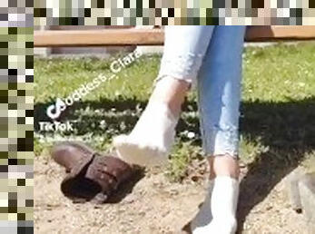 Girl take off her boots outdoor