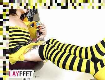 Sexy girl in a bee cosplay costume and striped stockings