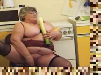 Old fat whore caresses pussy with vegetables and cums