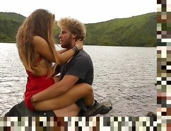 Horny couple pleasuring each other and making love passionately at a volcanic cater lake