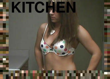Cute babe cooks in kitchen