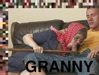 Granny with glasses is eager to taste him