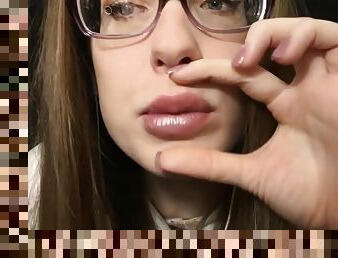 Amateur in glasses plays with her lips