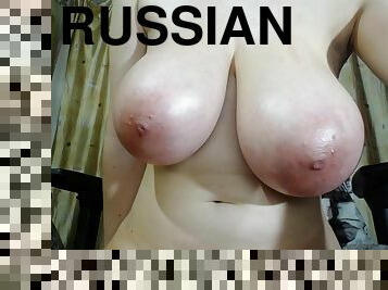 A hot Russian cam girl with H-cup breasts puts on a camshow