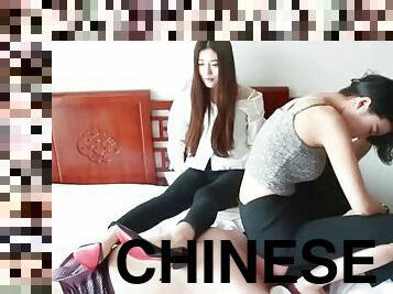 Two chinese ladies in high heels punish a man