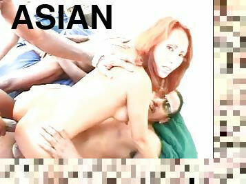 Redheaded asian chick playing with three cocks