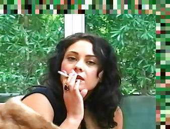 Sexy brunette poses while smoking