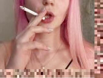 Nude girl with pink hair smoking a cigarette