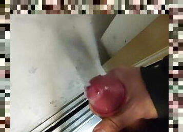 Solo male jerking off in the lift and cumming on the floor with the door open