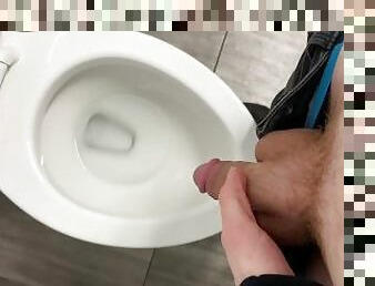 Pissing in a public toilet.