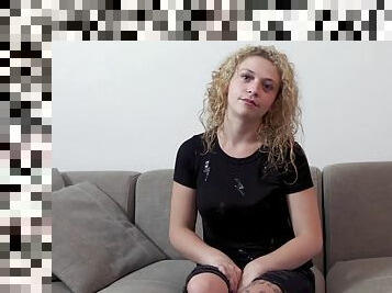 Curly haired blonde woman bangs on a casting sofa