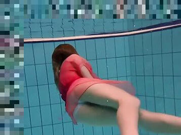 Hot lady takes her lovely red dress and shows her body underwater