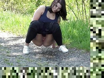 Thick booty girl takes a piss on a walk outdoors