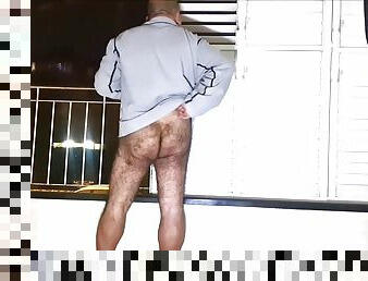 Bottomless dad waiting on the balcony, hoping to get caught