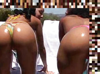 Oiled up ebony bikini girls fool around